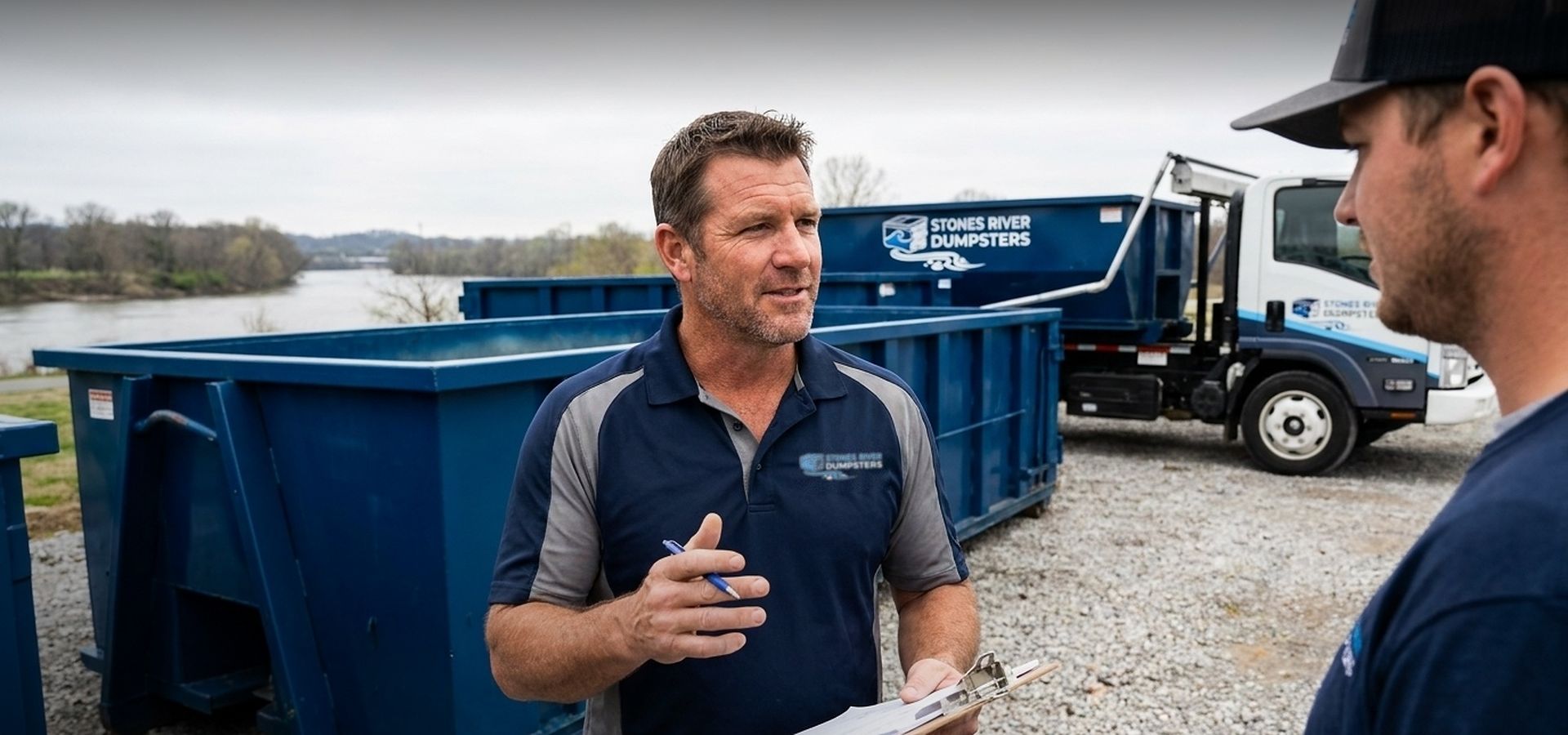 Stones River Dumpsters crew with roll-off containers and a delivery truck on the Stones River in Murfreesboro