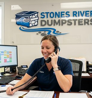 Claire, Stones River Dumpsters dispatcher, taking a booking in the office